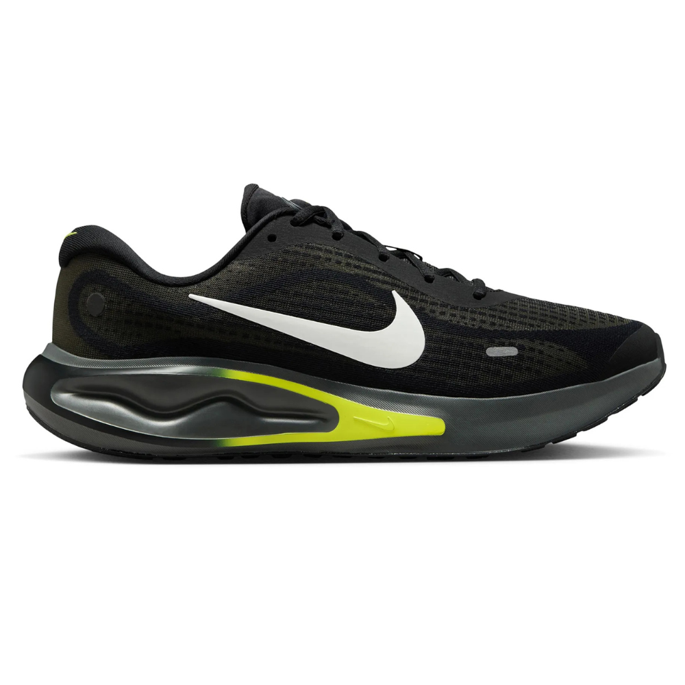 A black running shoe featuring a white swoosh logo, yellow accents, and a visible air cushion on the sole for impact protection.