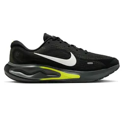 A black running shoe featuring a white swoosh logo, yellow accents, and a visible air cushion on the sole for impact protection.