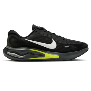 A black running shoe featuring a white swoosh logo, yellow accents, and a visible air cushion on the sole for impact protection.