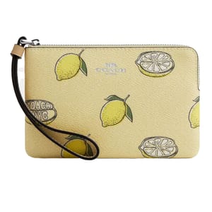 Coach Outlet Summer Wristlet features a lemon print on a light beige background, includes a brown wrist strap, and showcases the Coach NYC logo.