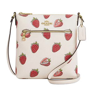 The Coach Outlet Rowan Crossbody features a playful strawberry print on a white background, with a gold zipper pocket, Coach logo, and a detachable tag. The bag includes an adjustable strap for easy carrying.