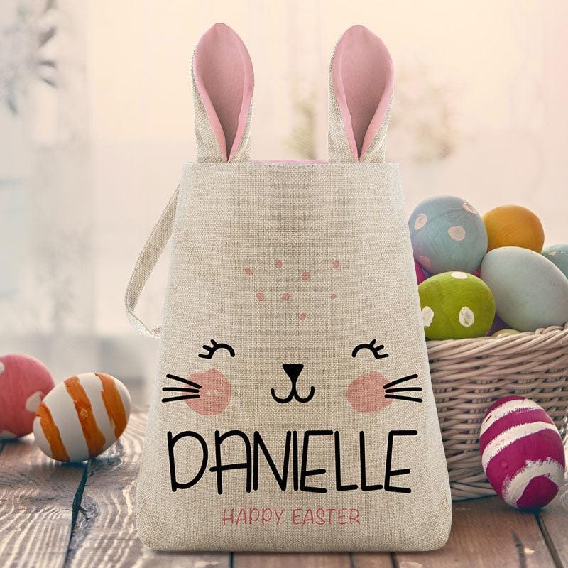 Bunny Easter Bag with pink-lined ears, a cute bunny face, and the name \“Danielle\“ on it. The bag says \“Happy Easter\“ below the name and is surrounded by colorful Easter eggs.