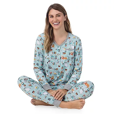 A person is wearing a Cuddl Duds pajama set featuring a light blue color with a whimsical print and grey trim at the cuffs.