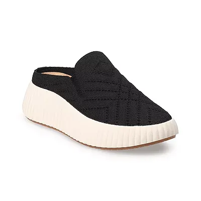 Black knit slip-on shoes with a chunky white sole and a small, visible pink heel label.