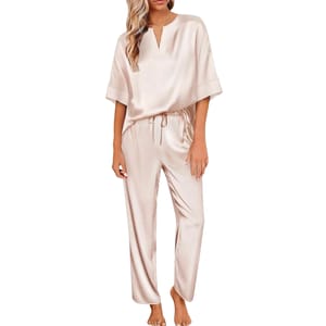 Women's satin pajamas in a light cream color, featuring a loose-fitting top with short sleeves and a round neckline, paired with matching drawstring pants.