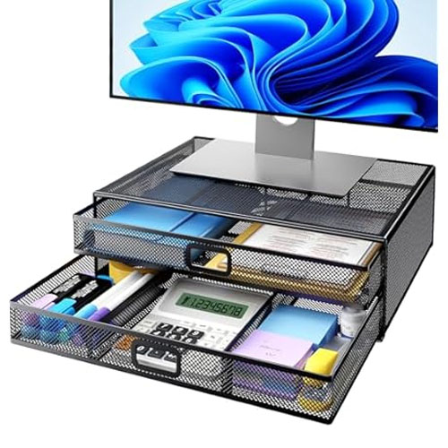 A black mesh desktop organizer with two sliding drawers is used as a monitor stand, holding items like a calculator, stationery, and a notebook.