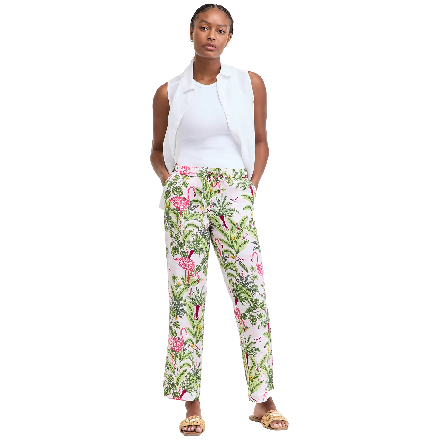 Women's 100% Linen Pull-On Palm Pants feature a colorful tropical print with flamingos and palm leaves on a white background. They are paired with a white sleeveless top and sandals.