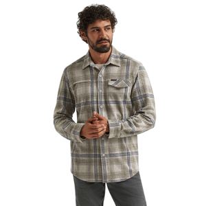 A man is wearing a plaid long-sleeve button-up shirt in beige, with a chest pocket and gray pants.