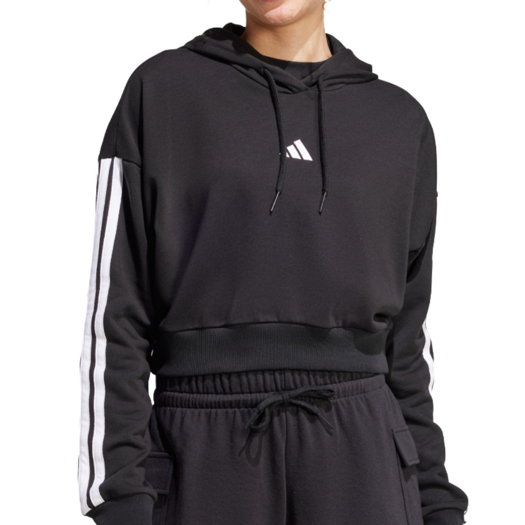 A black Adidas cropped hoodie with white stripes on the sleeves and a logo on the chest, paired with black drawstring track pants.