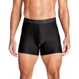 A model is wearing black Under Armour boxer briefs with prominent branding on the waistband.