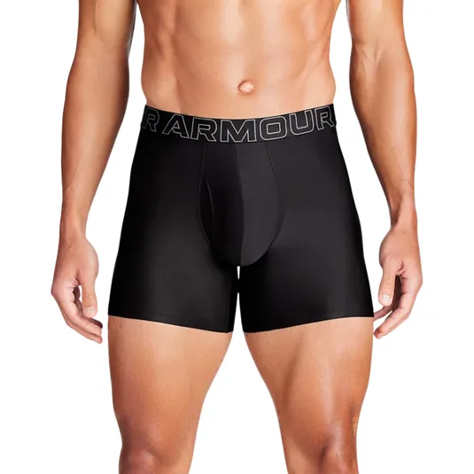 A model is wearing black Under Armour boxer briefs with prominent branding on the waistband.