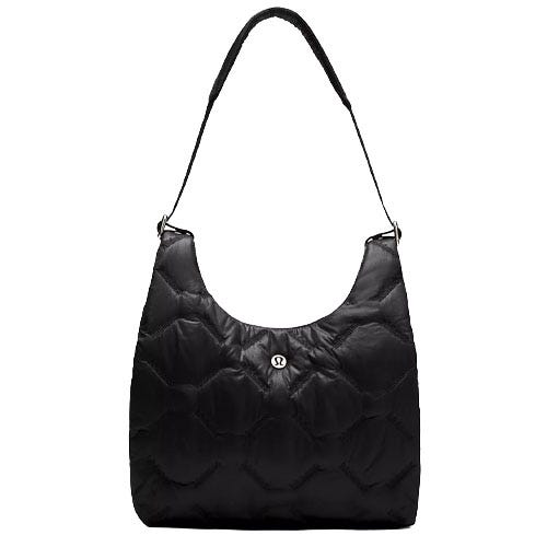 A black quilted shoulder bag with a padded strap and a central round logo detail, featuring a spacious design.