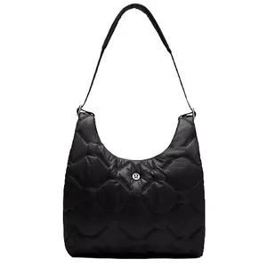 A black quilted shoulder bag with a padded strap and a central round logo detail, featuring a spacious design.