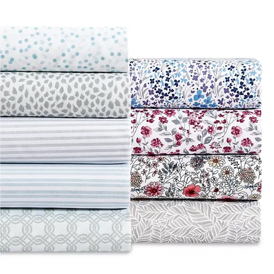 A collection of bed sheets in various patterns, including polka dots, stripes, floral designs, and geometric prints, in colors like blue, red, and gray.