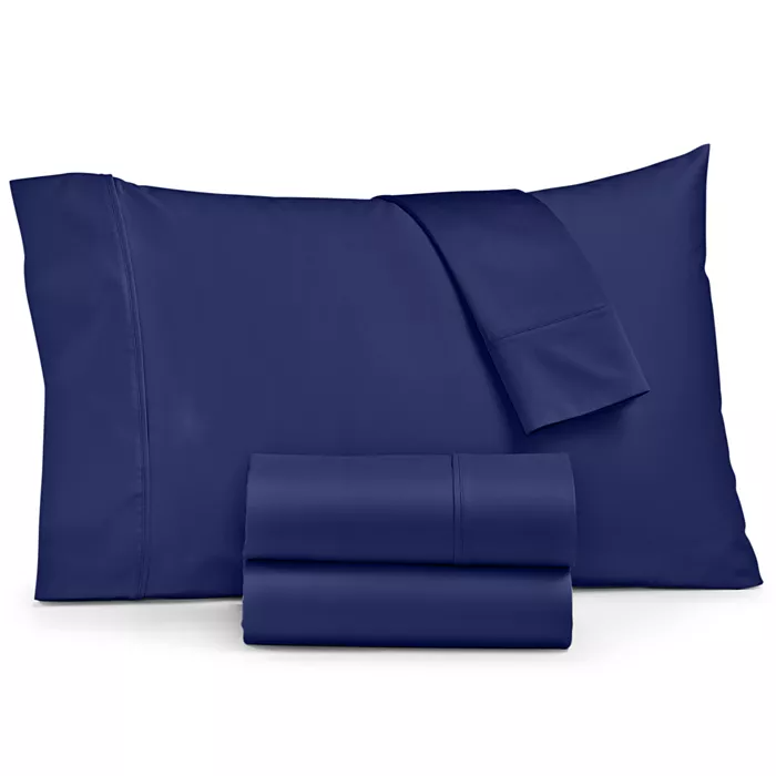A navy blue bed sheet set including a pillowcase, flat sheet, and fitted sheet.