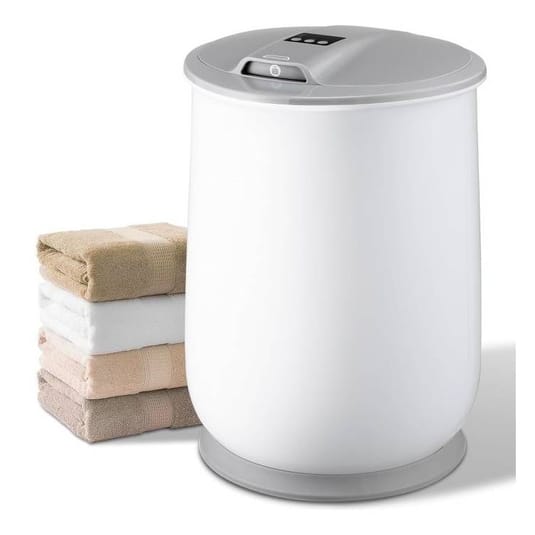 A white electronic towel warmer with a gray lid is shown next to a neatly stacked set of four folded towels in various neutral colors.