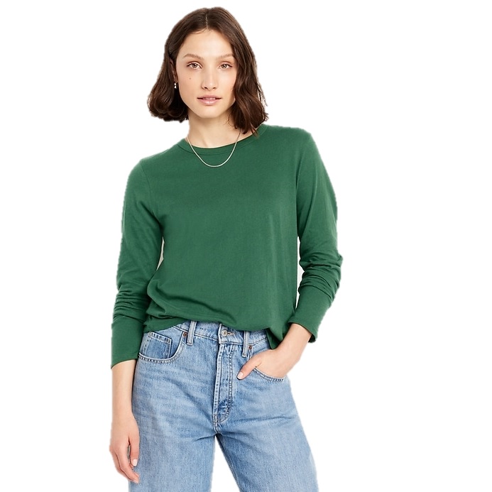 A person wearing a green long-sleeve shirt paired with light blue jeans.