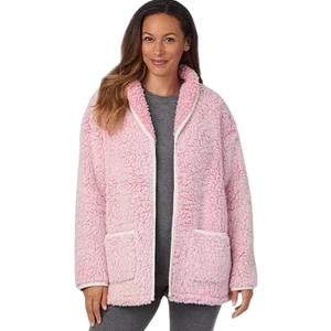 A woman wears a cozy pink, sherpa-lined jacket with front pockets over gray leggings.