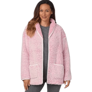 A woman wears a cozy pink, sherpa-lined jacket with front pockets over gray leggings.