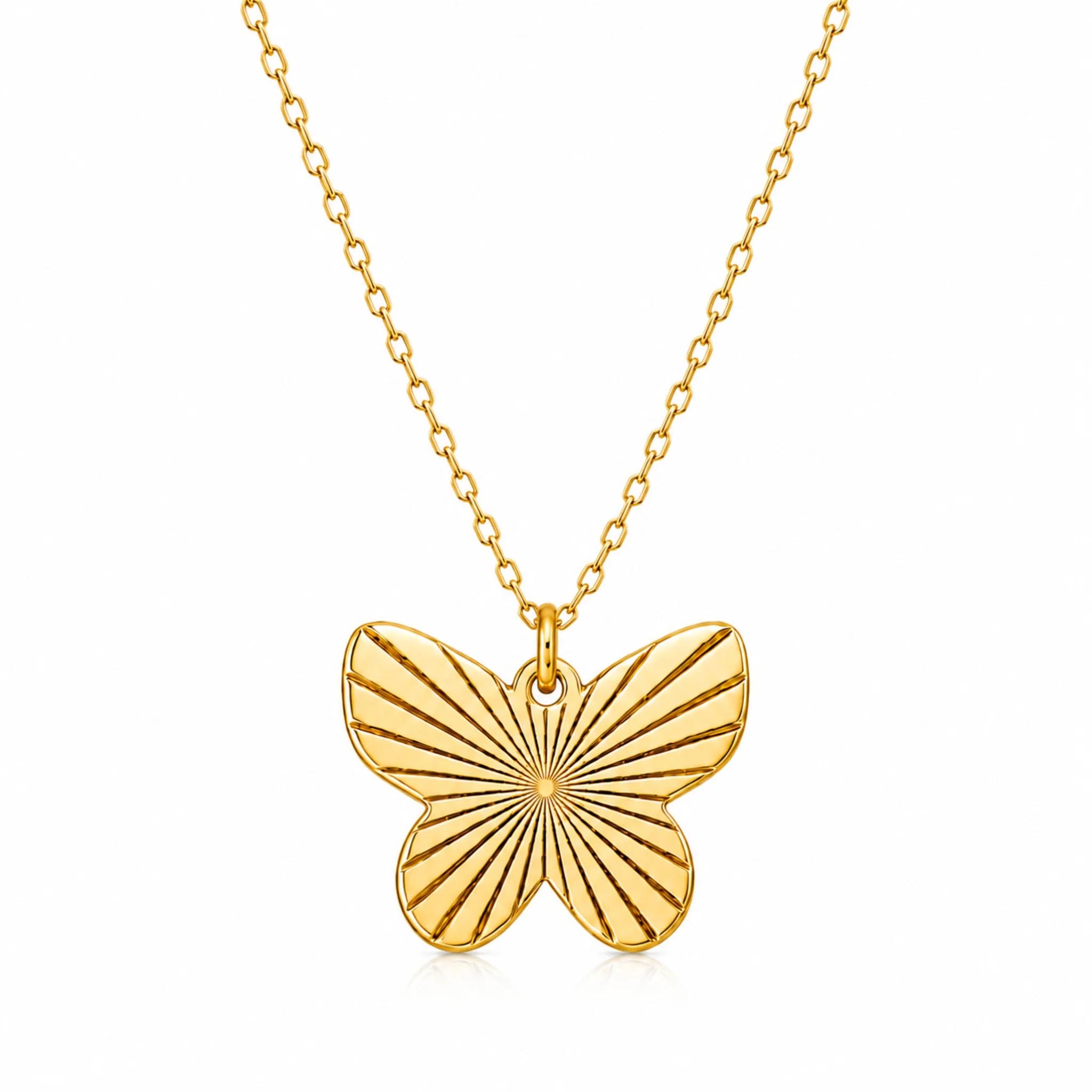 A gold necklace features a butterfly-shaped pendant with engraved sunburst lines, attached to a delicate chain.