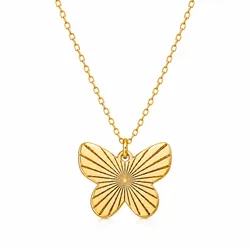 A gold necklace features a butterfly-shaped pendant with engraved sunburst lines, attached to a delicate chain.