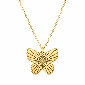 A gold necklace features a butterfly-shaped pendant with engraved sunburst lines, attached to a delicate chain.