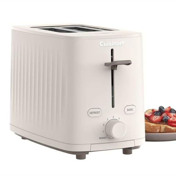 A white Cuisinart toaster with defrost and bagel functions, adjustable browning control, and a lever, next to a plate with toast topped with berries.