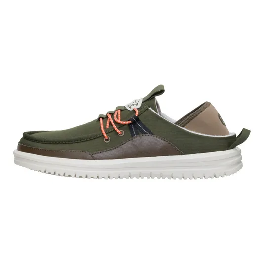 A low-cut casual shoe with an olive green fabric upper, brown accents, orange laces, white sole, and pull tab at the heel.