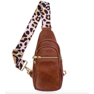 Brown leather sling bag featuring a leopard-print strap, gold zippers, and multiple compartments for easy organization.