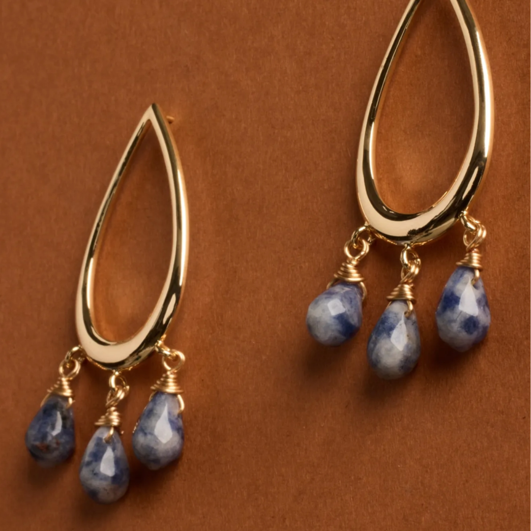 Gold teardrop earrings with three dangling blue, faceted beads wrapped in gold wire.