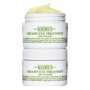 Kiehl's Creamy Eye Treatment with Avocado is pictured, showcasing an open and closed jar against a green background.
