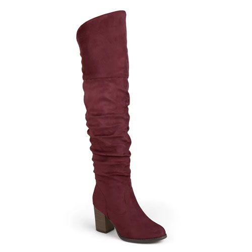 A red knee-high boot with a slouchy design and a chunky wooden heel.