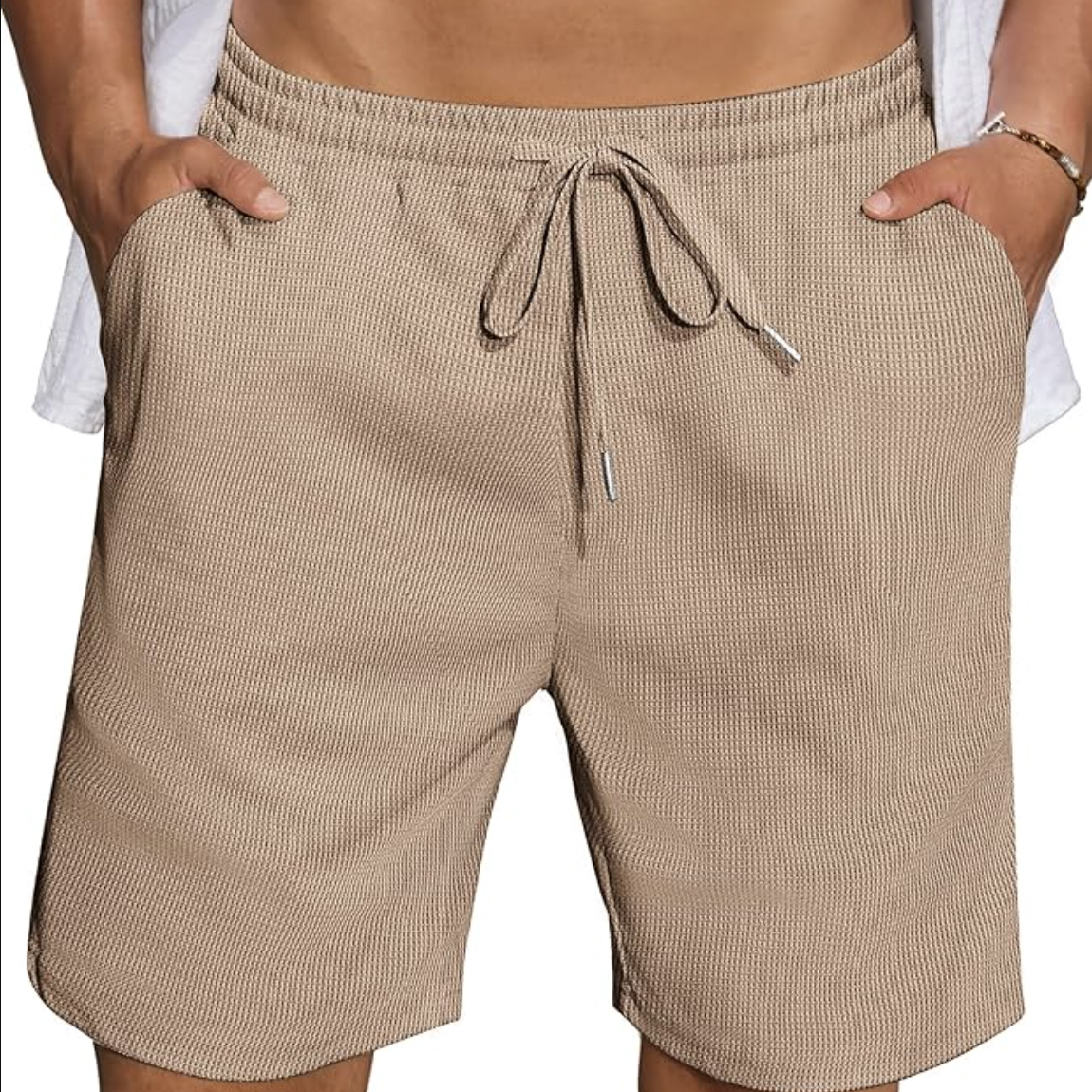 Beige textured drawstring shorts with elastic waistband and side pockets.