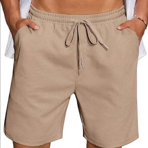 Beige textured drawstring shorts with elastic waistband and side pockets.