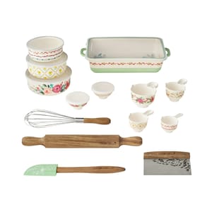 The 20-piece Pioneer Woman Bakeware Set includes floral and patterned bowls, measuring cups, a whisk, rolling pin, spatula, scraper, and a green-handled rectangular baking dish, all adorned with vintage-inspired designs.