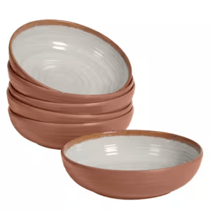 A stack of terracotta bowls with white interiors.