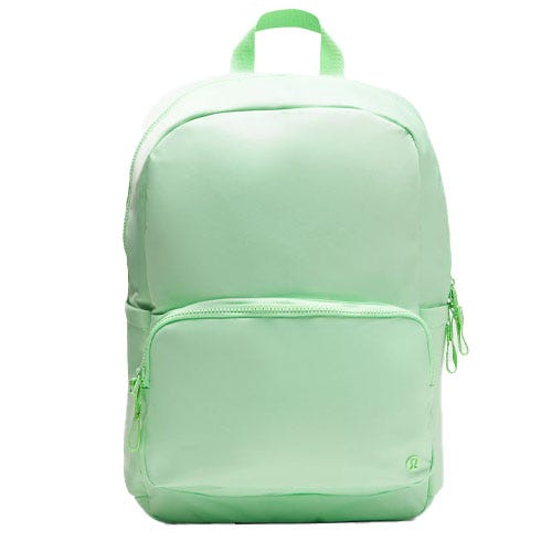 A light green backpack with a large main compartment, a smaller front pocket, and a top handle.