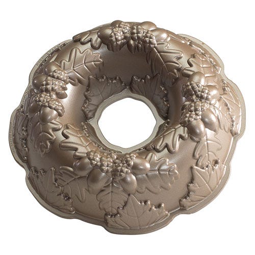 A decorative Bundt cake pan featuring intricate leaves and acorn designs.