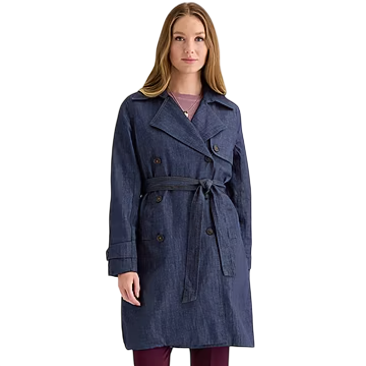 A woman is wearing a blue denim trench coat with a tied belt, double-breasted buttons, and notched lapels. She pairs it with a pink shirt and maroon pants.