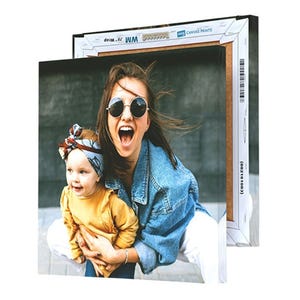 A square canvas print displaying a joyful woman in sunglasses and a child in a yellow sweater with a headband, with another canvas behind it showing similar framing.