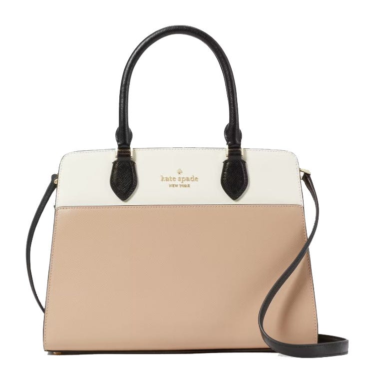 Kate Spade Colorblock Madison Satchel features a two-tone design in beige and white with black handles and a detachable strap. It has gold-tone hardware and the brand's logo on the front.