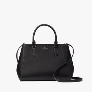 A black Kate Spade tote bag with top handles and a detachable shoulder strap.