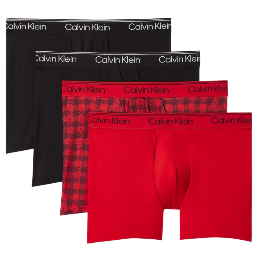 A set of four Calvin Klein boxer briefs in black and red, including one with a red geometric pattern, each with a branded waistband.