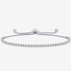 Silver bracelet with a single row of clear gemstones and adjustable closure.
