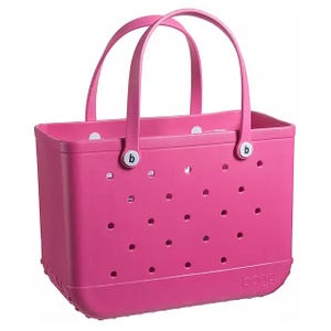 A pink tote bag with small holes and two handles, featuring round buttons with the letter \“b\“ on them.