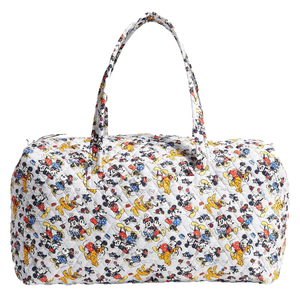 A Vera Bradley duffel bag featuring an all-over Disney print with characters like Mickey Mouse and Pluto on a white quilted fabric. The bag has two handles and a zippered top.