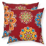 Two decorative pillows featuring a vibrant, multicolored floral pattern on a red background.