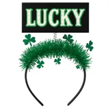 A green headband with tinsel adornment features green shamrocks and a spring-mounted sign that reads \“LUCKY\“ in white and green letters.