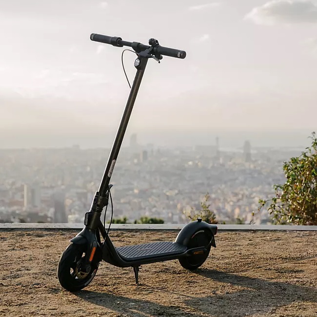 An electric scooter with city skyline in the background.