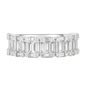 A ring with a double row of round and baguette-cut diamonds set in a band, showcasing a luxurious and sparkling design.
